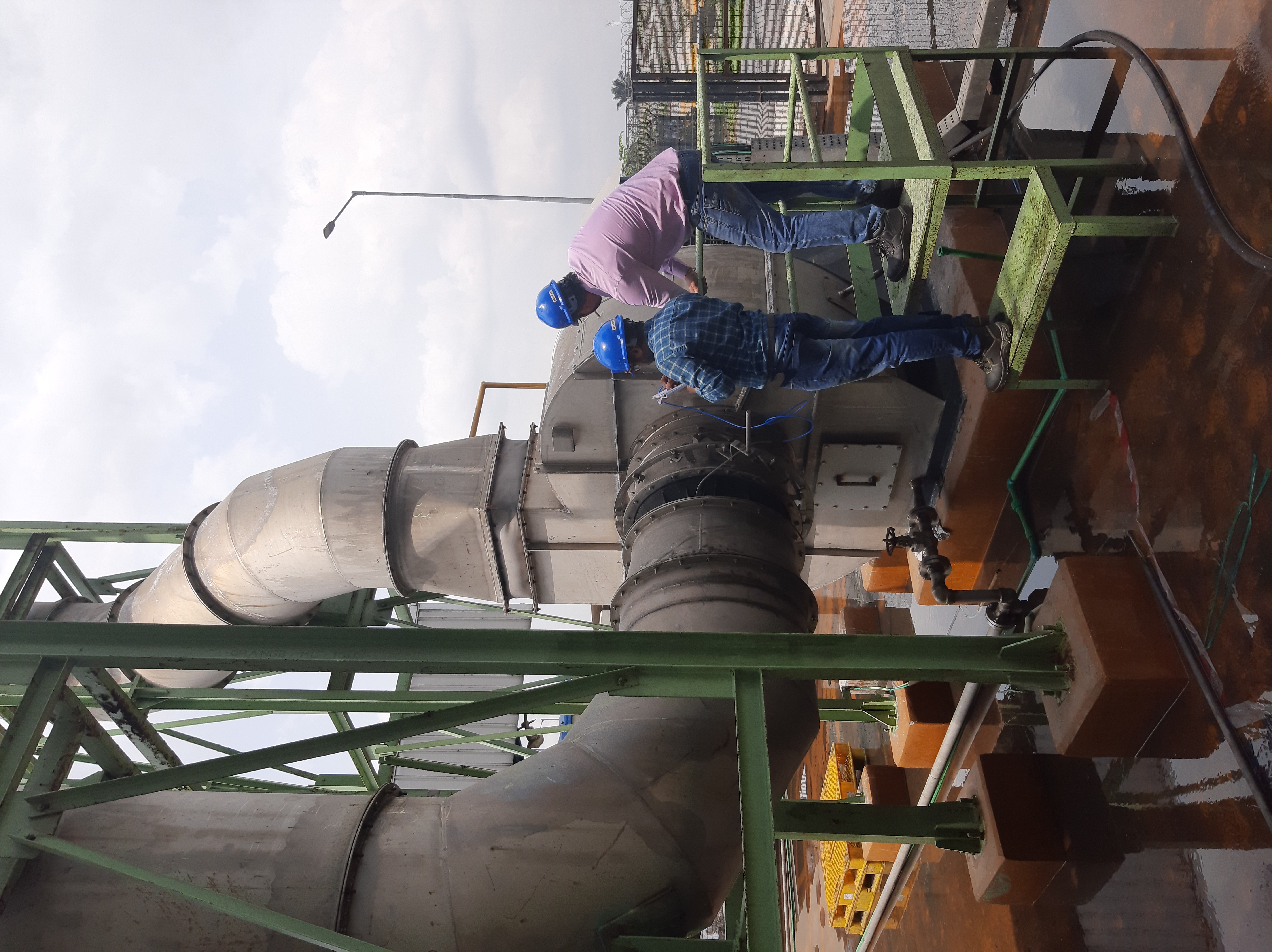 Auditors taking readings on a process plant pump and piping circuit