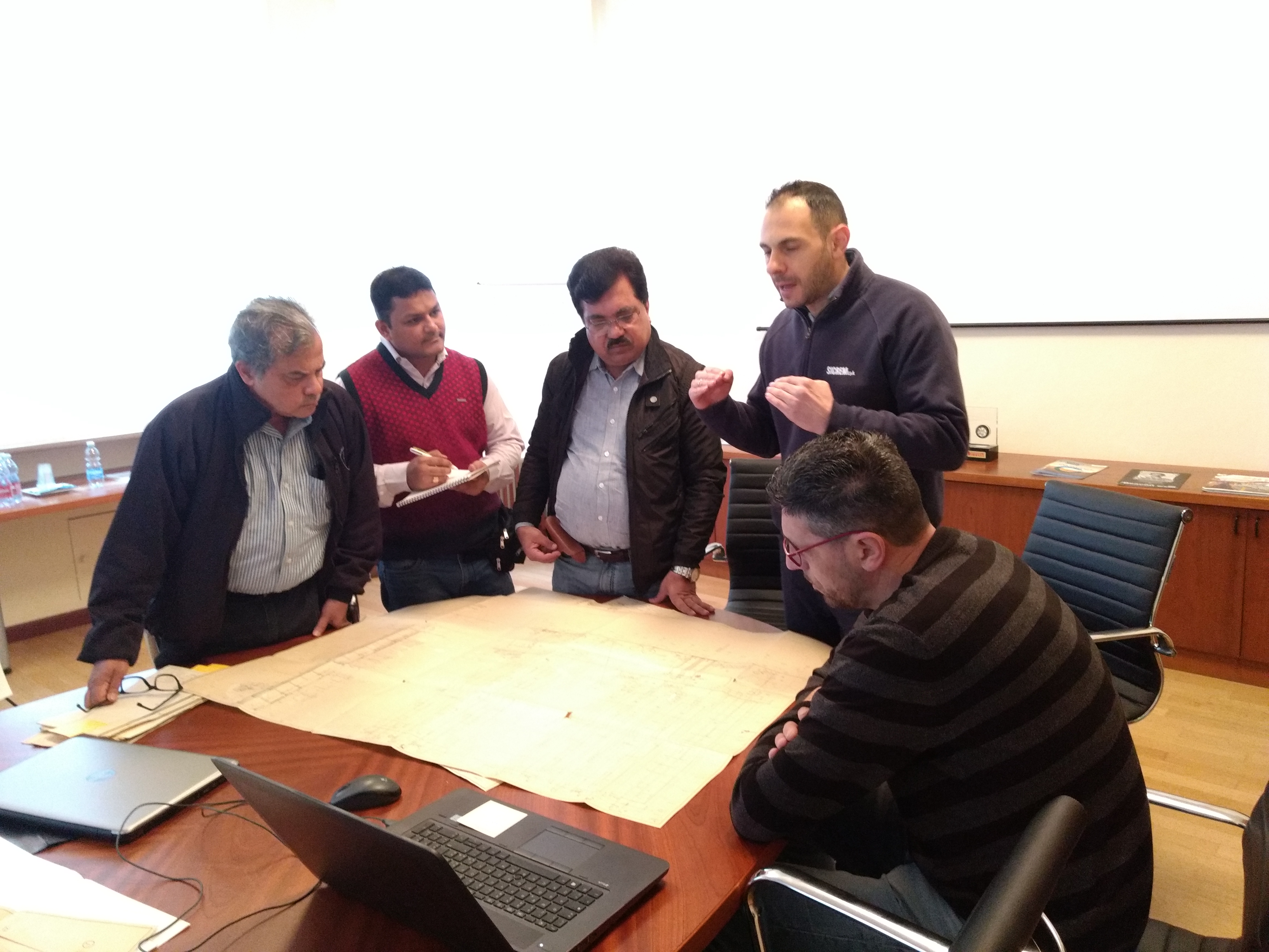 Reviewing plant drawings with an equipment manufacturer in Italy