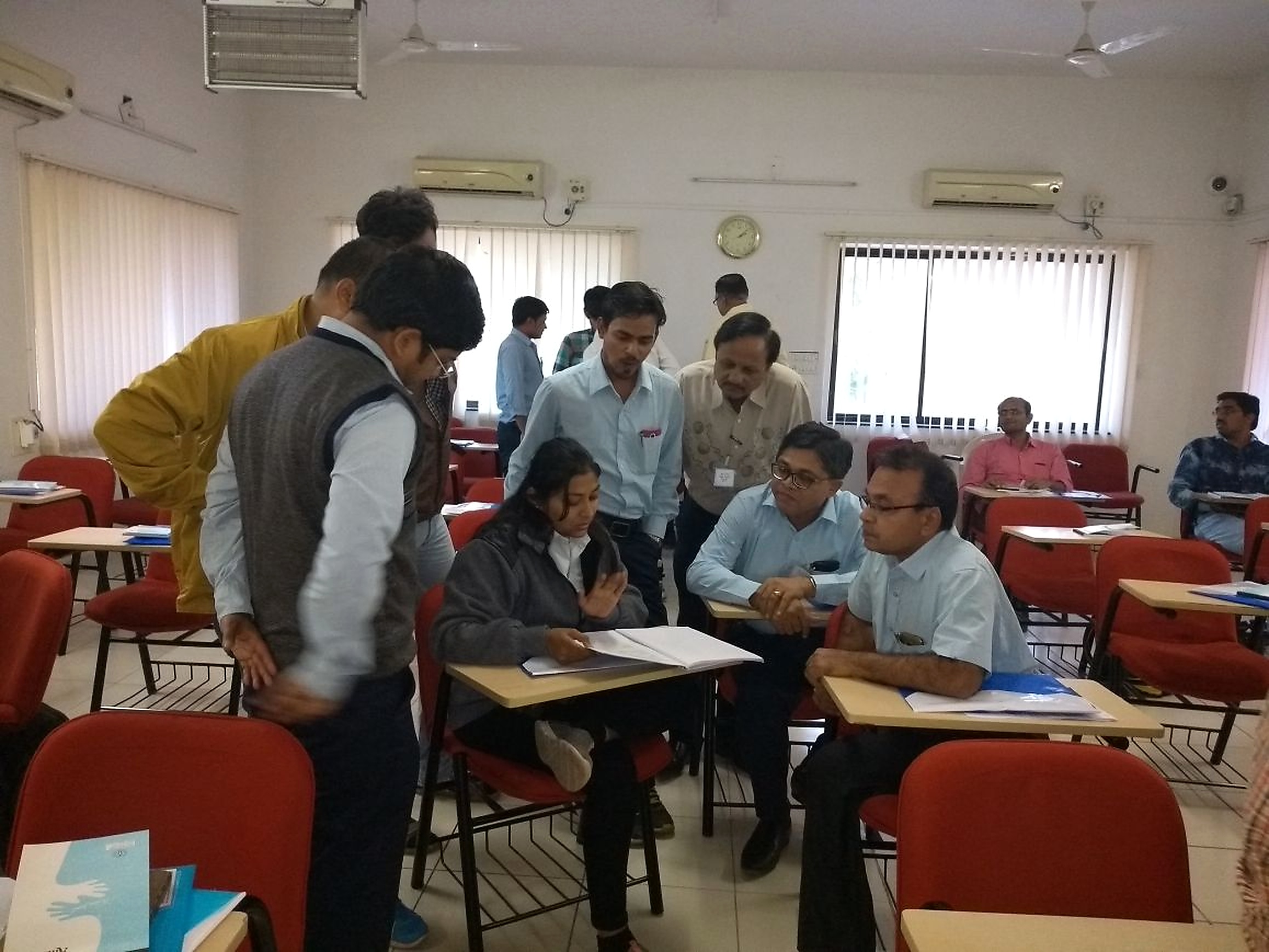 Participants reviewing course material together during a group discussion