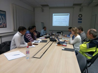 Presenting energy audit findings to plant management in a meeting room